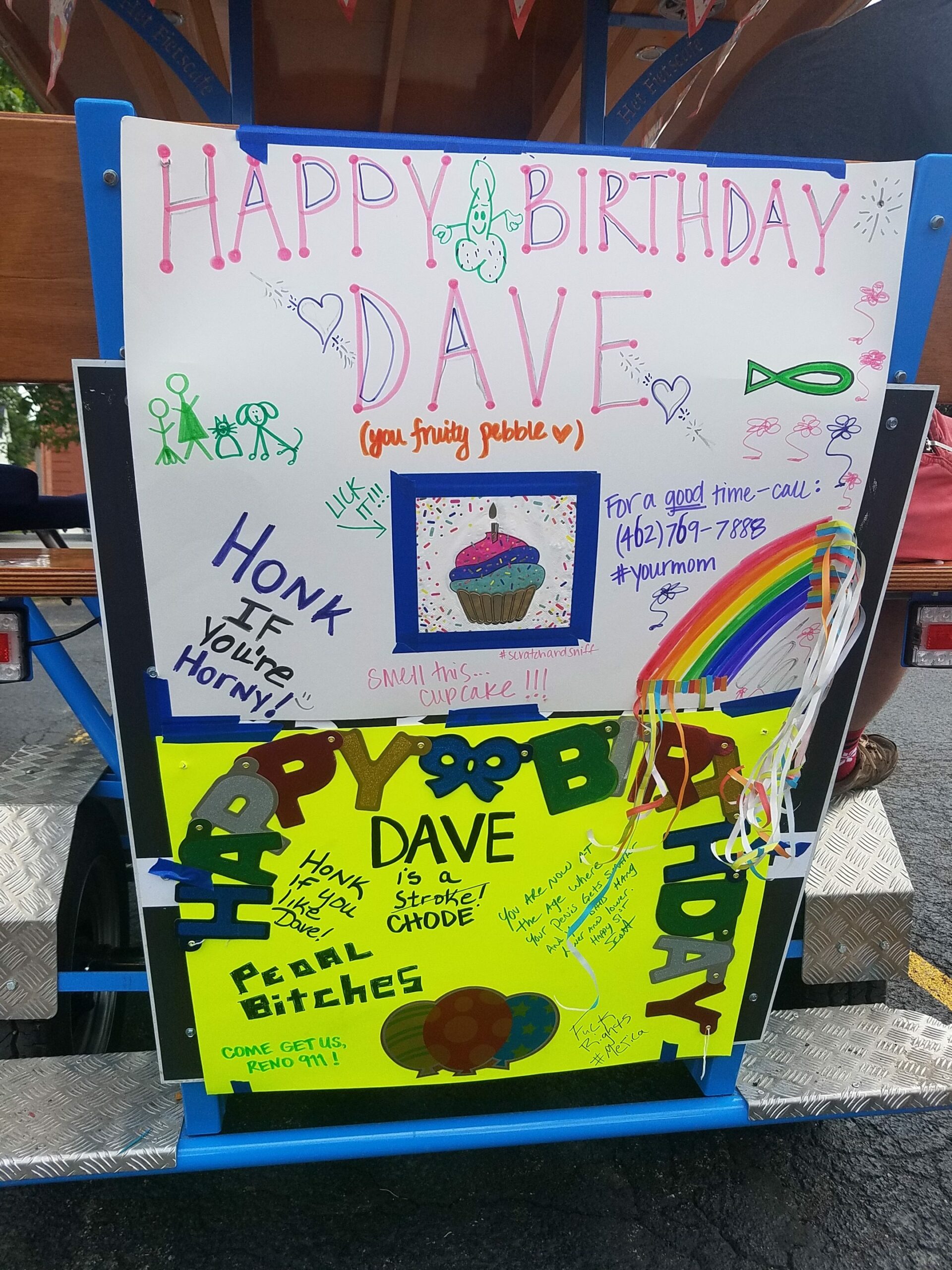 sign on the back of a pedal pub with alot of colors saying happy birthday Dave